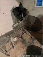 stacked metal chairs, umbrella wrapped, table top leaning