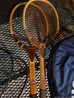Two wooden Davis Imperial tennis racquets leaning together