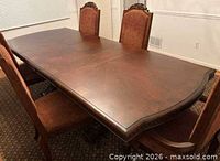 Full view of dark wood dining table surface and shape
