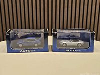 Both boxed model cars side by side