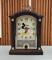 Front view showing dial, Mickey Mouse graphic, case style and musical plaque