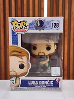 Front view of boxed Funko Pop Luka Doncic #128 showing figure and packaging details