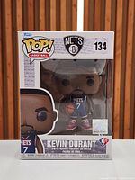 Front view of boxed Funko POP Kevin Durant figure showing character, number 134, Nets logo, and factory seal