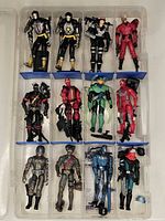 Overall view of 12 G.I. Joe figures arranged in organizer case