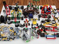 Overview of assembled Technic models, loose parts in bags, various wheels and components