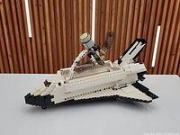 Full view of assembled Lego Space Shuttle Discovery set on white surface