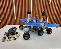 Main six-wheel rover and smaller rover with parts displayed