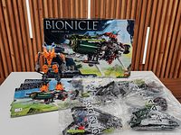 Full lot view with box, figure, manuals and sealed bags
