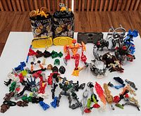 Overall view of lot on table: two canisters, assembled figures, loose parts