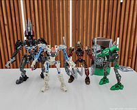 Front view of four assembled Bionicle figures standing side by side