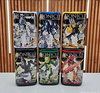 Front view of six Bionicle Stars canisters
