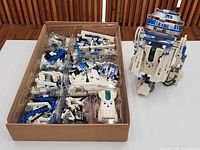 Sorted LEGO parts in clear trays and built R2-D2 model