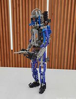 Front-left view of assembled Jango Fett Technic figure with blaster