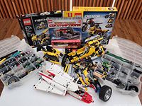 Overview of lot showing storage cases, Technic parts piles and three Lego set boxes