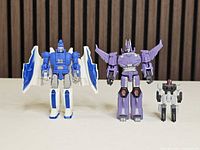 Front view of all three figures standing side by side