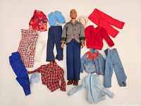 Group shot of Ken doll surrounded by all clothing items
