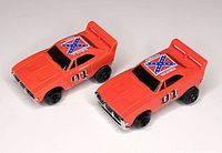 Top view of both General Lee cars showing decals and overall design