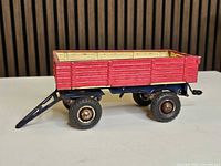 side view showing red panels, blue chassis, wheels and tilt bar
