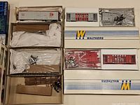 Six Walthers boxes opened showing unassembled HO freight car kits and parts