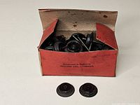 Open box filled with metal wheelsets, two wheelsets placed in front
