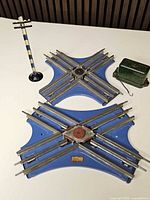 Overall lot showing two blue crossings, striped pole, green control box