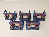 Five blue Hornby buffer stops front view