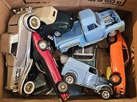 Top view of box showing multiple assembled model cars in various colors