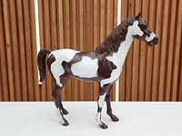 Side view of brown and white Marx Storm Cloud horse figurine