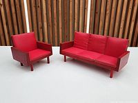 Red three-seat sofa and matching armchair