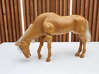 Left side view of articulated palomino horse standing