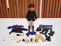Group shot of Sindy doll standing with all clothing and accessories laid out