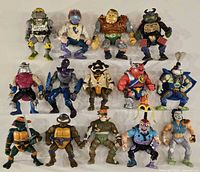 Group shot of all fourteen vintage Playmates TMNT action figures arranged in three rows