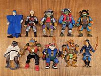 Group shot of all 10 TMNT figures on wood surface