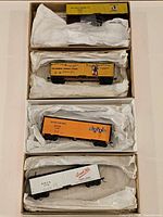 Overview of all four HO scale freight cars in open boxes