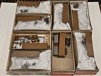 All eight boxed kits opened showing parts, bodies, hardware