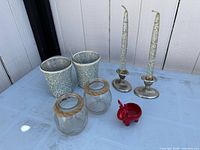 All candle holders and candles displayed on surface