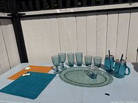 Full set on table including glasses, mugs, tray, pitcher and placemats