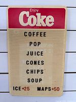 Front view of Coca-Cola menu board showing header and lettered menu items