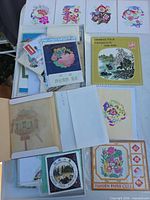 Top-down view showing several sealed packets, booklets, loose butterfly samples
