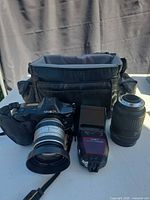 Camera body, both lenses, flash, bag grouped