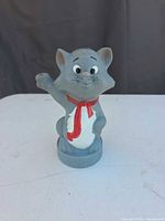 Front view of grey Berlioz coin bank standing on round base