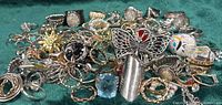 Overhead view of full assortment of rings spread out on green fabric