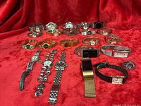 All twenty-three watches displayed on red fabric