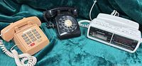 Overview of all three telephones on green fabric