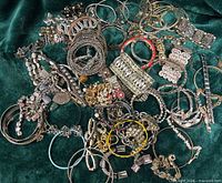 overhead view full lot of bracelets on green cloth