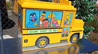 Left side view showing bus graphics and Sesame Street Toy Box decal