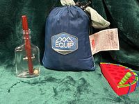 All three items—hammock in bag, bottle puzzle, watermelon puzzle—group shot