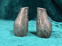 Front view of both sterling silver shakers showing overall shape and tarnish