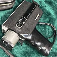 Left side view of Canon Zoom 250 Super 8 camera showing pistol grip and case corner