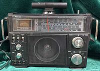 Front view showing speaker grille, control panel, tuning scale, dual way meter